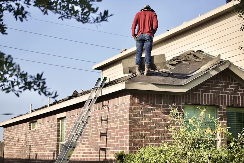 Professional roofer working on a residential roof in Centre Island